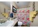 Bathroom featuring a vanity, toilet, and bathtub with shower and a vibrant floral shower curtain at 338 Rc Thompson Rd, Dallas, GA 30157