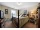 Cozy bedroom with wood floors, a four poster bed, and light colored walls at 338 Rc Thompson Rd, Dallas, GA 30157
