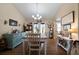 Bright dining room featuring hardwood floors, chandelier, and wainscoting at 338 Rc Thompson Rd, Dallas, GA 30157