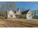 Traditional home featuring a two-car garage, well-maintained lawn, and covered front porch at 338 Rc Thompson Rd, Dallas, GA 30157