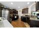 Modern kitchen featuring dark wood cabinets, granite countertops, and stainless steel appliances at 338 Rc Thompson Rd, Dallas, GA 30157