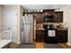 Bright kitchen with dark wood cabinets, stainless steel refrigerator and appliances and a wood-look floor at 338 Rc Thompson Rd, Dallas, GA 30157