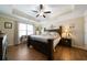 Spacious main bedroom featuring a trey ceiling, large bed, wood floors, and lots of natural light at 338 Rc Thompson Rd, Dallas, GA 30157