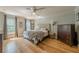 Bright bedroom with hardwood floors, windows, ceiling fan, and neutral color palette at 5215 Silver Creek Dr, Lilburn, GA 30047