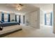 This bedroom is decorated in neutral colors with a blue bed and a daybed in a spacious area at 5215 Silver Creek Dr, Lilburn, GA 30047