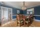 Elegant dining room features blue walls, chandelier, and wood floors at 5215 Silver Creek Dr, Lilburn, GA 30047