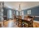Dining area with hardwood floors, chandelier, and blue accent walls at 5215 Silver Creek Dr, Lilburn, GA 30047