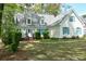 Well-manicured lawn, and a charming house with dormer windows and blue shutters at 5215 Silver Creek Dr, Lilburn, GA 30047