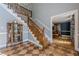 Grand foyer featuring wooden staircase and decorative tile flooring at 5215 Silver Creek Dr, Lilburn, GA 30047