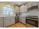 Updated kitchen boasts stainless steel appliances, granite countertops, subway tile backsplash, and natural light at 5215 Silver Creek Dr, Lilburn, GA 30047