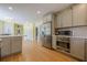 Spacious kitchen with stainless steel appliances, ample counter space, and an open layout to the breakfast area at 5215 Silver Creek Dr, Lilburn, GA 30047