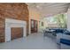Inviting screened porch with brick fireplace, comfortable seating, and outdoor living space at 5215 Silver Creek Dr, Lilburn, GA 30047