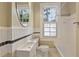Charming bathroom featuring tile accents, modern fixtures, and a bright window at 811 Ponce De Leon Ne Pl, Atlanta, GA 30306