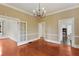 Traditional dining room with wood floors, chandelier, and access to kitchen, blending charm and function at 811 Ponce De Leon Ne Pl, Atlanta, GA 30306