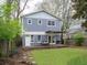 View of a two-story home with grey siding, a deck, and mature trees at 811 Ponce De Leon Ne Pl, Atlanta, GA 30306