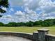 Expansive green space with mature trees and landscaping on a sunny day beneath a vibrant blue sky with puffy clouds at 811 Ponce De Leon Ne Pl, Atlanta, GA 30306