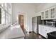 Charming kitchen with stainless steel refrigerator, white cabinets, and views to the front yard at 811 Ponce De Leon Ne Pl, Atlanta, GA 30306