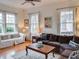 Inviting living room features hardwood floors, large windows with shutters, and comfortable seating at 811 Ponce De Leon Ne Pl, Atlanta, GA 30306