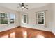 Bright bedroom with hardwood floors, white walls, and plenty of natural light from three large windows at 811 Ponce De Leon Ne Pl, Atlanta, GA 30306