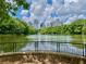Picturesque water view featuring a tranquil lake reflecting the city skyline, framed by lush trees and greenery at 811 Ponce De Leon Ne Pl, Atlanta, GA 30306