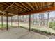 Spacious backyard with view under deck featuring green grass and trees in background at 1545 Smoke Hill Dr, Hoschton, GA 30548