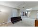 A spacious finished basement area provides carpeted floors and a dark futon at 1545 Smoke Hill Dr, Hoschton, GA 30548
