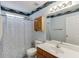 Bathroom featuring a shower and tub, toilet, light blue walls, and a wood vanity with mirror at 1545 Smoke Hill Dr, Hoschton, GA 30548