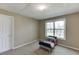 A cozy bedroom features a window view, carpeted floors, and neutral paint, with a small bed at 1545 Smoke Hill Dr, Hoschton, GA 30548