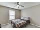 Bedroom with a ceiling fan, light brown walls and carpet, and a metal bed frame at 1545 Smoke Hill Dr, Hoschton, GA 30548