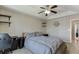 Bedroom with a ceiling fan, light brown walls and carpet, and decorative shelving at 1545 Smoke Hill Dr, Hoschton, GA 30548