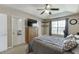 This bedroom features a ceiling fan, a large window, and a wall-mounted television at 1545 Smoke Hill Dr, Hoschton, GA 30548
