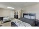 The bedroom features carpeted floors and is furnished with a queen-size bed, a nightstand, and a dresser at 1545 Smoke Hill Dr, Hoschton, GA 30548