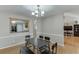 Stylish dining room featuring hardwood floors, an elegant chandelier, and open access to the living room at 1545 Smoke Hill Dr, Hoschton, GA 30548