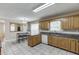 Charming kitchen with wood cabinets, granite countertops, stainless steel appliances and breakfast table at 1545 Smoke Hill Dr, Hoschton, GA 30548