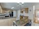 Charming kitchen with wood cabinets, granite countertops and breakfast table at 1545 Smoke Hill Dr, Hoschton, GA 30548