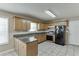 Charming kitchen features wood cabinets, gray countertops and tile floor at 1545 Smoke Hill Dr, Hoschton, GA 30548