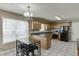 Charming kitchen features wood cabinets, gray countertops, tile floor and breakfast table with chandelier at 1545 Smoke Hill Dr, Hoschton, GA 30548