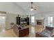 Spacious living room showcasing hardwood floors, a fireplace, and access to other rooms at 1545 Smoke Hill Dr, Hoschton, GA 30548