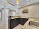 Basement bar area features granite countertops, dark wood cabinets and a stainless steel sink at 11770 Ashwick Pl, Johns Creek, GA 30005