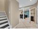 Finished basement featuring a wet bar, tiled flooring, and stairs leading to the upper level at 11770 Ashwick Pl, Johns Creek, GA 30005