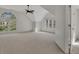 Spacious bedroom with a vaulted ceiling, fan, and multiple windows for natural light at 11770 Ashwick Pl, Johns Creek, GA 30005