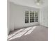 Bright bedroom with large windows, ceiling fan, and carpet flooring at 11770 Ashwick Pl, Johns Creek, GA 30005