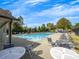 Enjoy a gorgeous day at the neighborhood swimming pool with ample seating and a beautiful sky at 11770 Ashwick Pl, Johns Creek, GA 30005