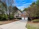 Attractive two-story home with a brick facade, well-maintained landscaping, and an expansive concrete driveway at 11770 Ashwick Pl, Johns Creek, GA 30005
