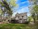 Back exterior view of the house with wooden deck at 11770 Ashwick Pl, Johns Creek, GA 30005