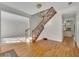 Bright foyer with hardwood floors, staircase with wrought iron railing and a glimpse of the open floor plan at 11770 Ashwick Pl, Johns Creek, GA 30005