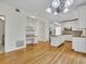 Bright kitchen with white cabinets, an island, stainless steel appliances, and a built-in desk area at 11770 Ashwick Pl, Johns Creek, GA 30005
