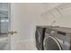Laundry room featuring a side-by-side washer and dryer and wire shelving at 11770 Ashwick Pl, Johns Creek, GA 30005