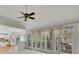 Open living area with large windows, curtains, a deck view, and a partial view of the kitchen at 11770 Ashwick Pl, Johns Creek, GA 30005