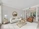Bright and spacious living room featuring elegant columns, a comfortable sofa, and an inviting dining area at 11770 Ashwick Pl, Johns Creek, GA 30005
